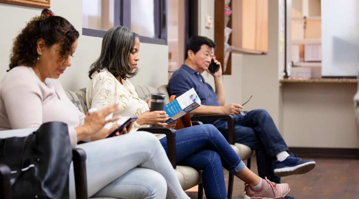 Mature woman reads brochure while waiting for medical appointment