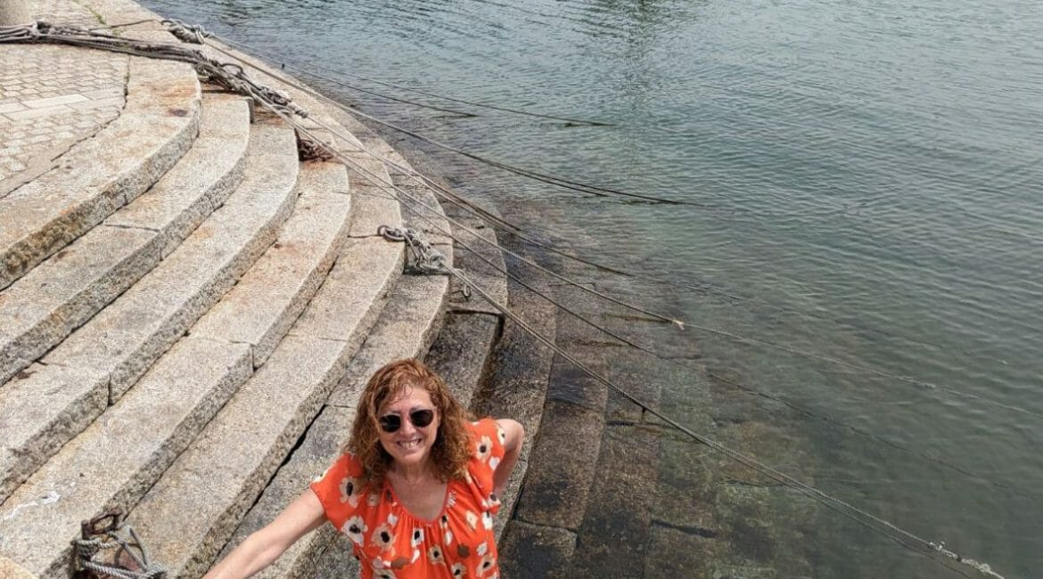 hilary dipping her feet in the water at the fishing port